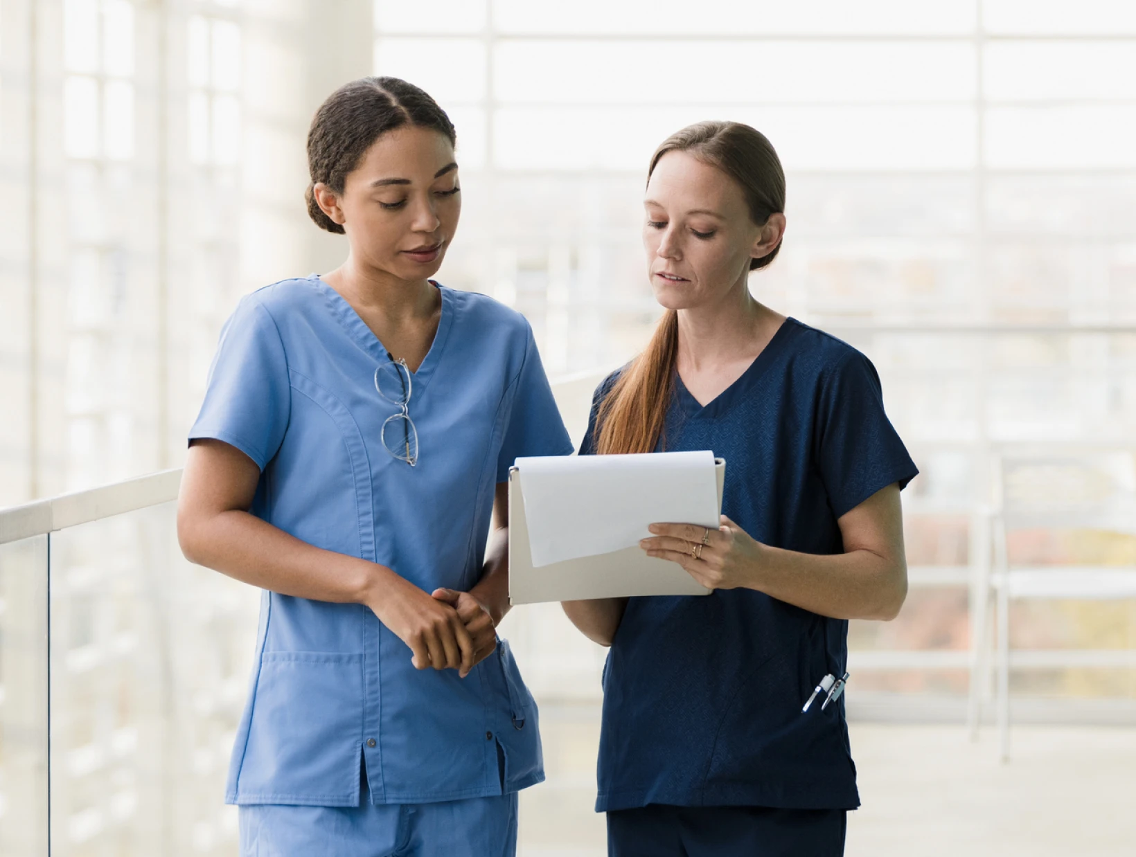 Medical staff collaborating in hospital corridor
